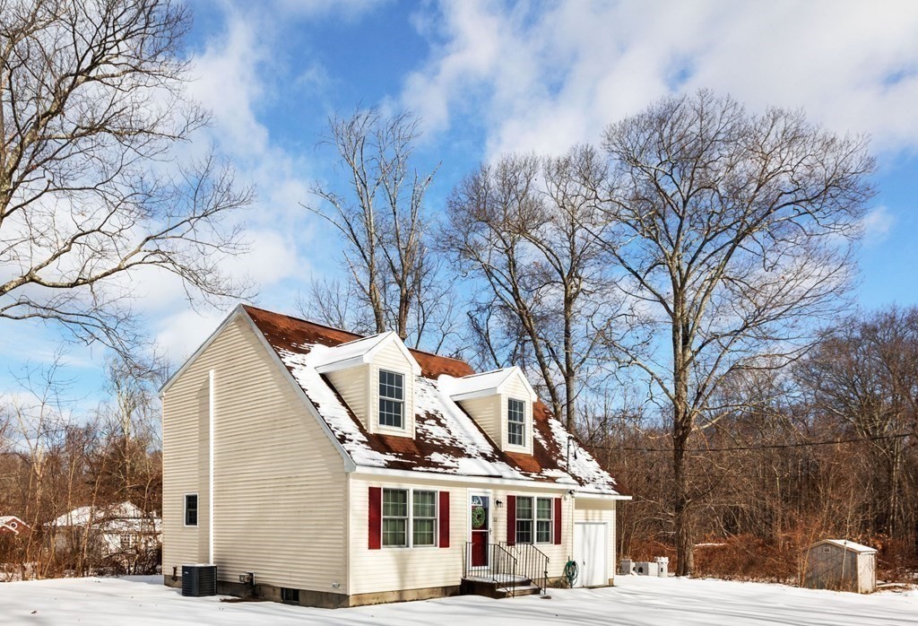 22 Oak Road Littleton, MA 01460 - Photo 30 of 42 a view of a white house with a large tree