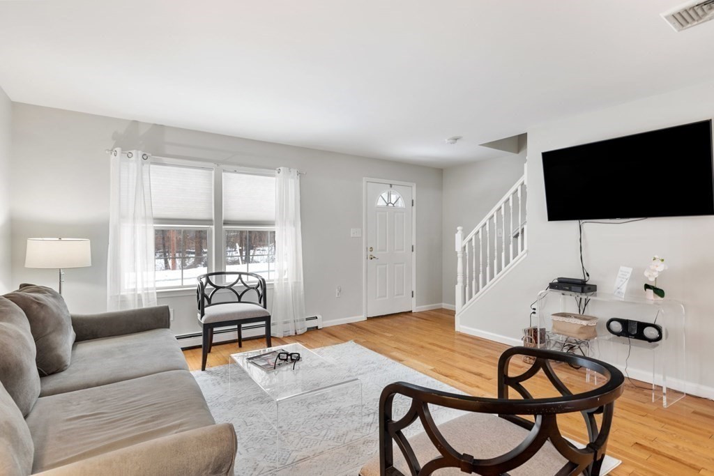 22 Oak Road Littleton, MA 01460 - Photo 3 of 42 a living room with furniture and a flat screen tv
