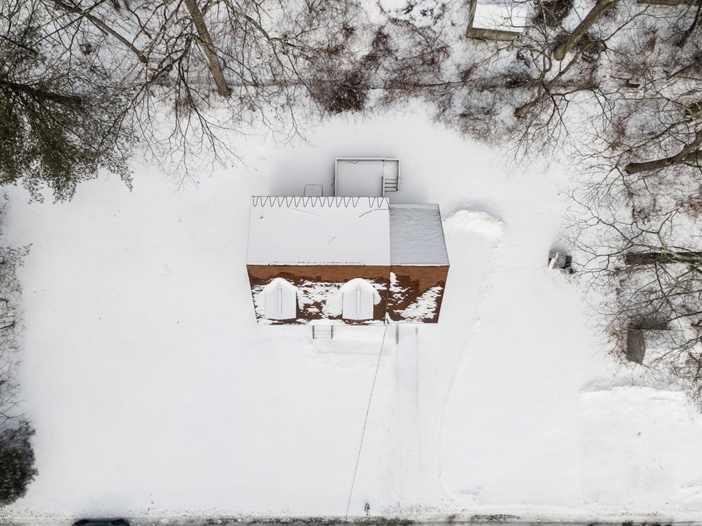 22 Oak Road Littleton, MA 01460 - Photo 32 of 42 with a bench sitting in middle of snow