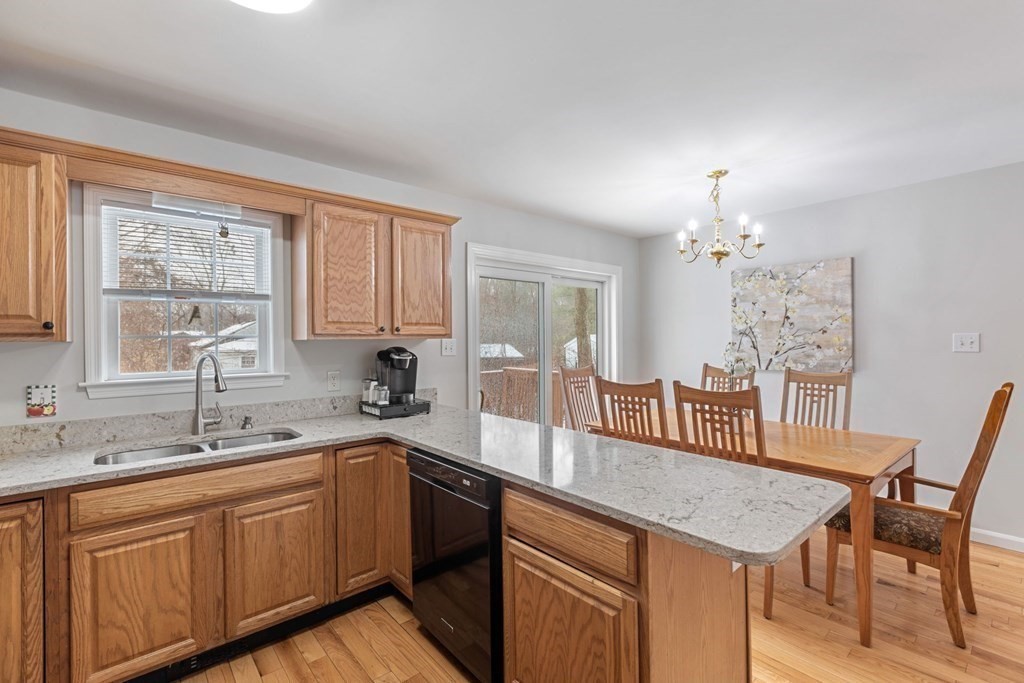 22 Oak Road Littleton, MA 01460 - Photo 8 of 42 a kitchen with a table chairs sink and cabinets