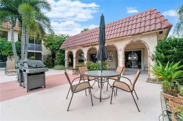 a view of a house with backyard and sitting area