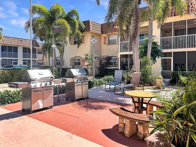 a view of a chairs and table in backyard
