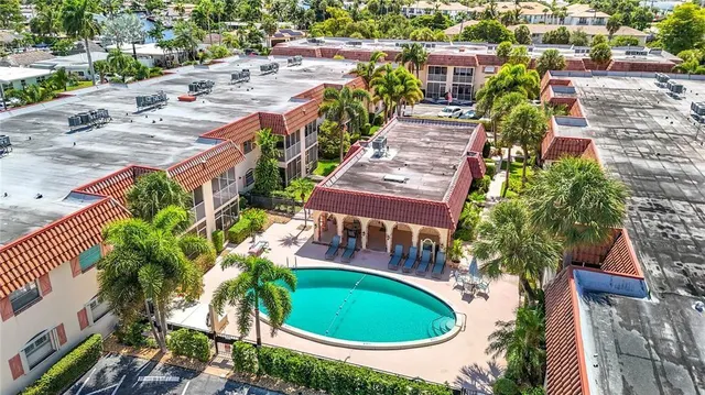 an aerial view of residential house with outdoor space and swimming pool
