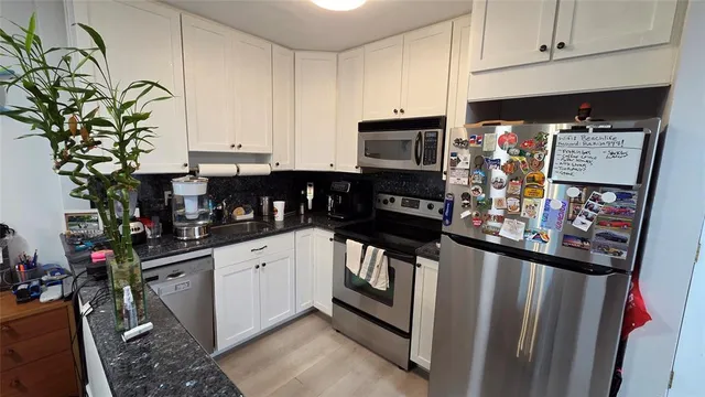 a kitchen with stainless steel appliances a stove a microwave and a refrigerator