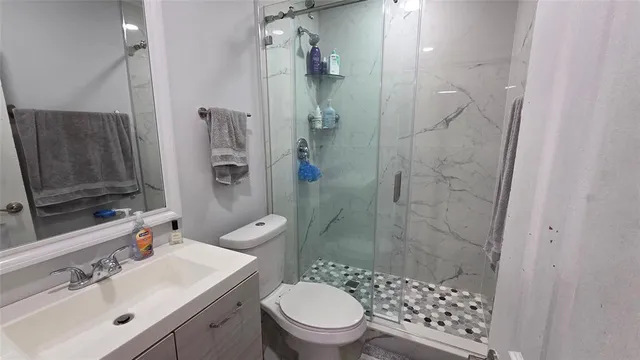 a bathroom with a sink toilet and shower