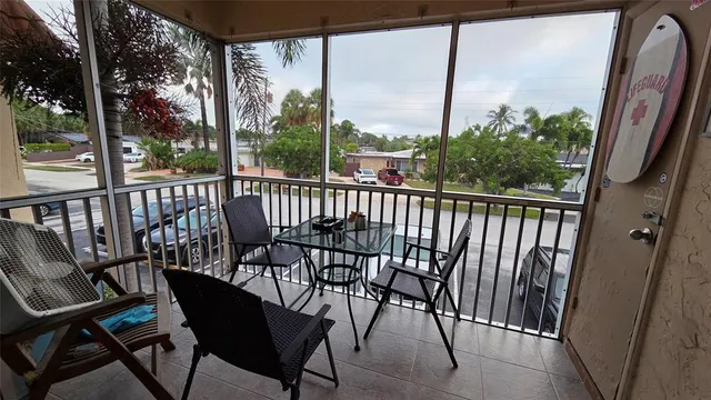 a view of a chairs and table in the balcony
