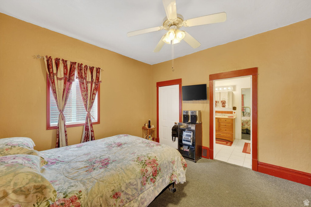 977 23rd Street Ogden, UT 84401 - Photo 7 of 29 Bedroom with light colored carpet, a ceiling fan, and connected bathroom