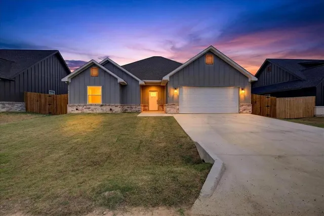 a view of a house with a yard and garage