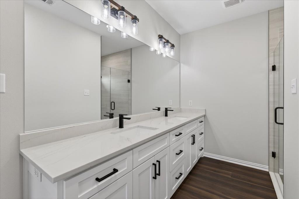 117 East Bexar Street Mabank, TX 75147 - Photo 11 of 27 a bathroom with a double vanity sink and mirror
