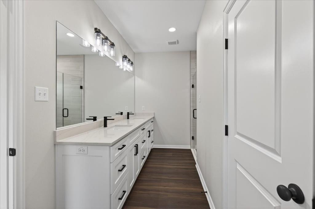 117 East Bexar Street Mabank, TX 75147 - Photo 12 of 27 a spacious bathroom with a double vanity sink and a mirror