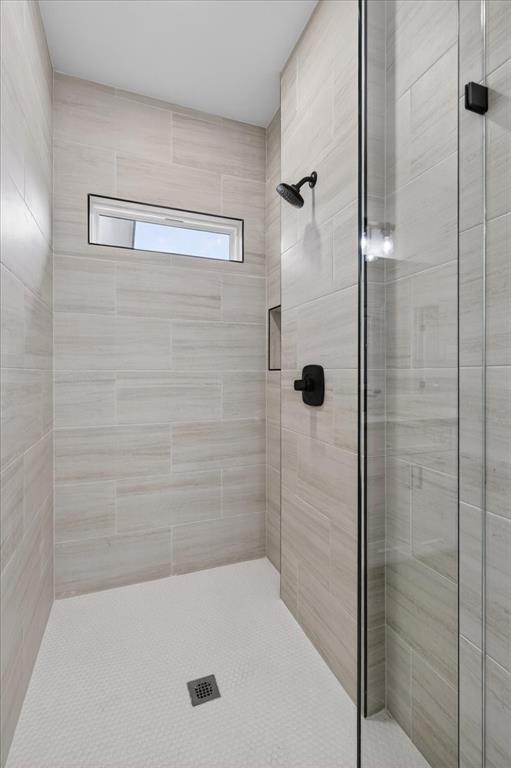 117 East Bexar Street Mabank, TX 75147 - Photo 13 of 27 a bathroom with a bathtub and a shower