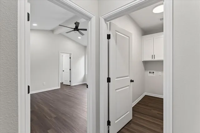 a view of a hallway with wooden floor and closet area
