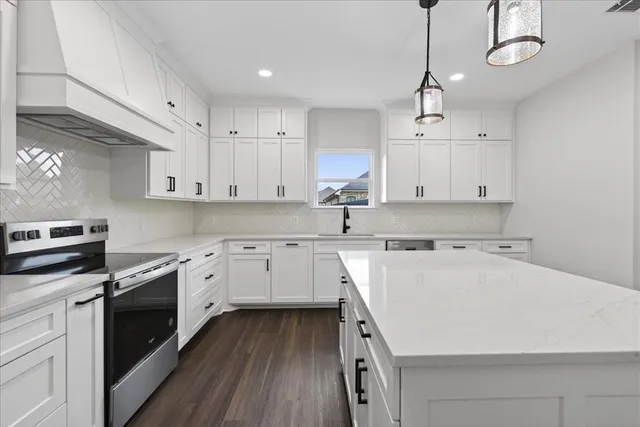 a kitchen with a sink a stove and cabinets