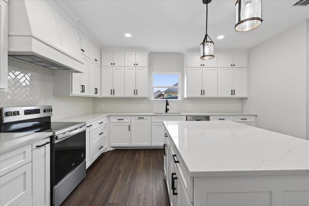 117 East Bexar Street Mabank, TX 75147 - Photo 6 of 27 a kitchen with a sink a stove and cabinets