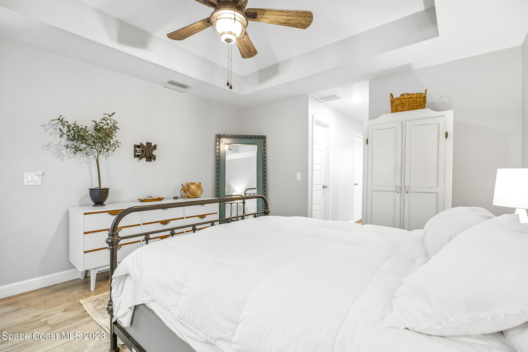 1003 Hayden Road Rockledge, FL 32955 - Photo 17 of 29 a bedroom with a bed and a chandelier