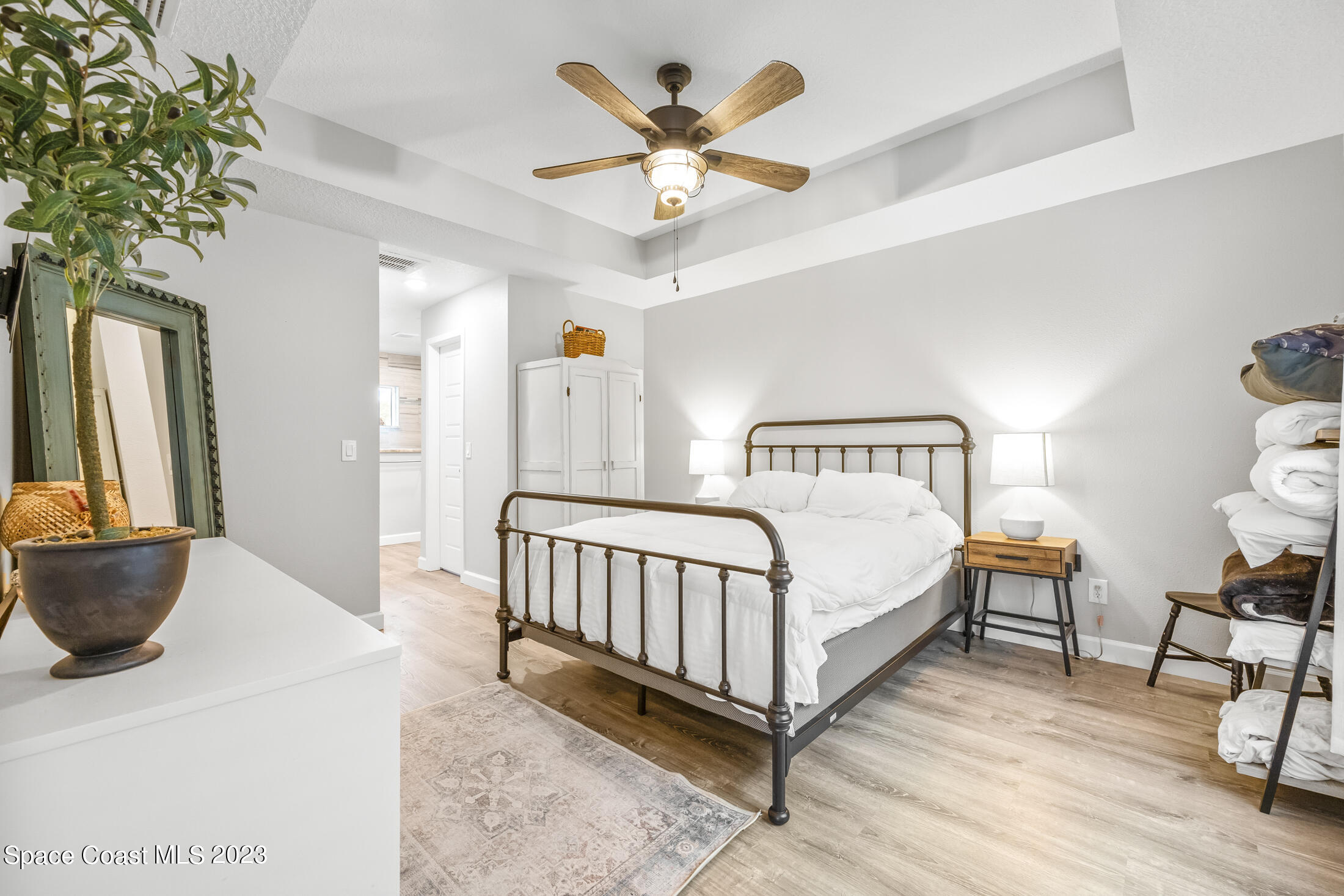 1003 Hayden Road Rockledge, FL 32955 - Photo 18 of 29 a bedroom with a bed and a chandelier