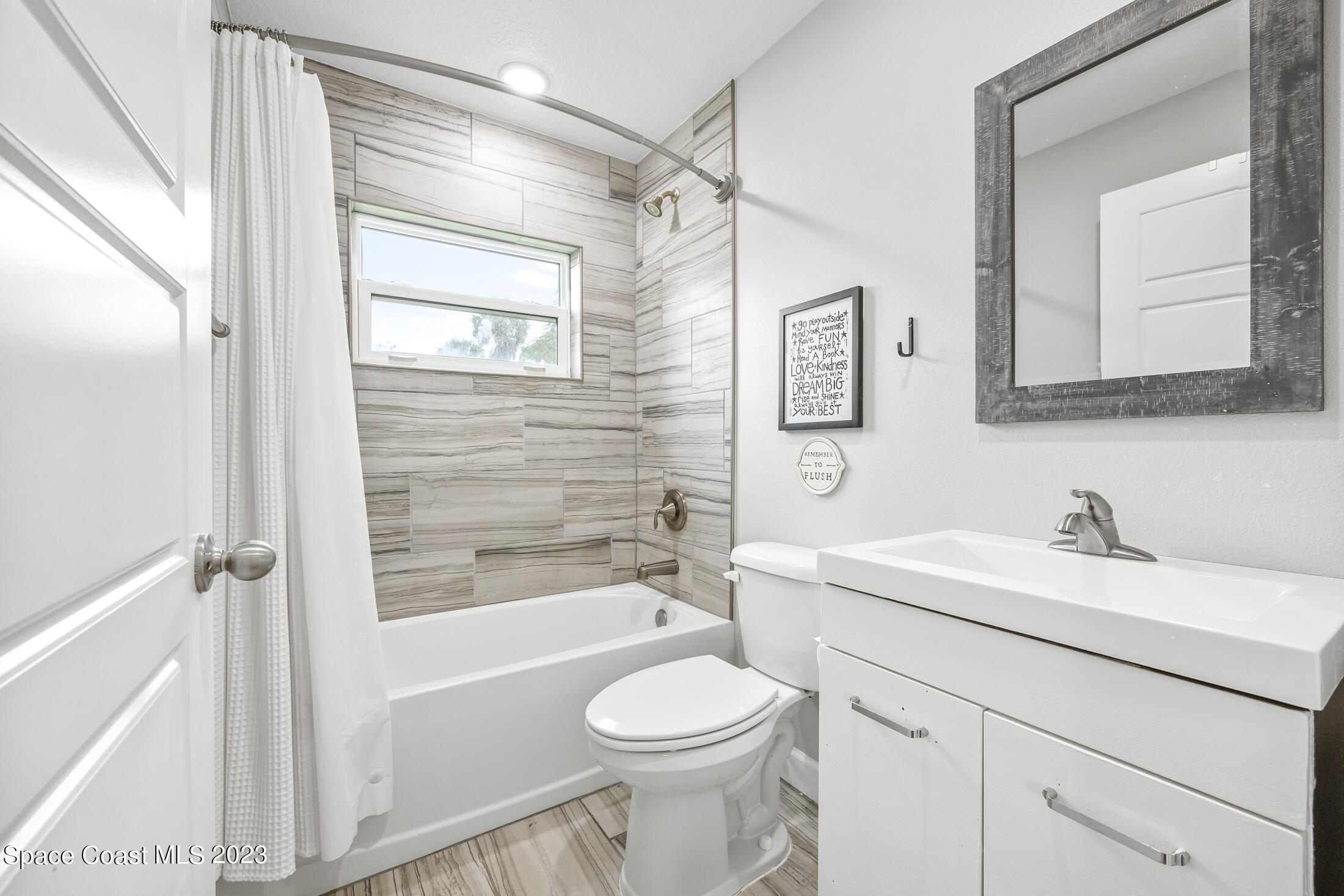1003 Hayden Road Rockledge, FL 32955 - Photo 19 of 29 a bathroom with a sink toilet and shower