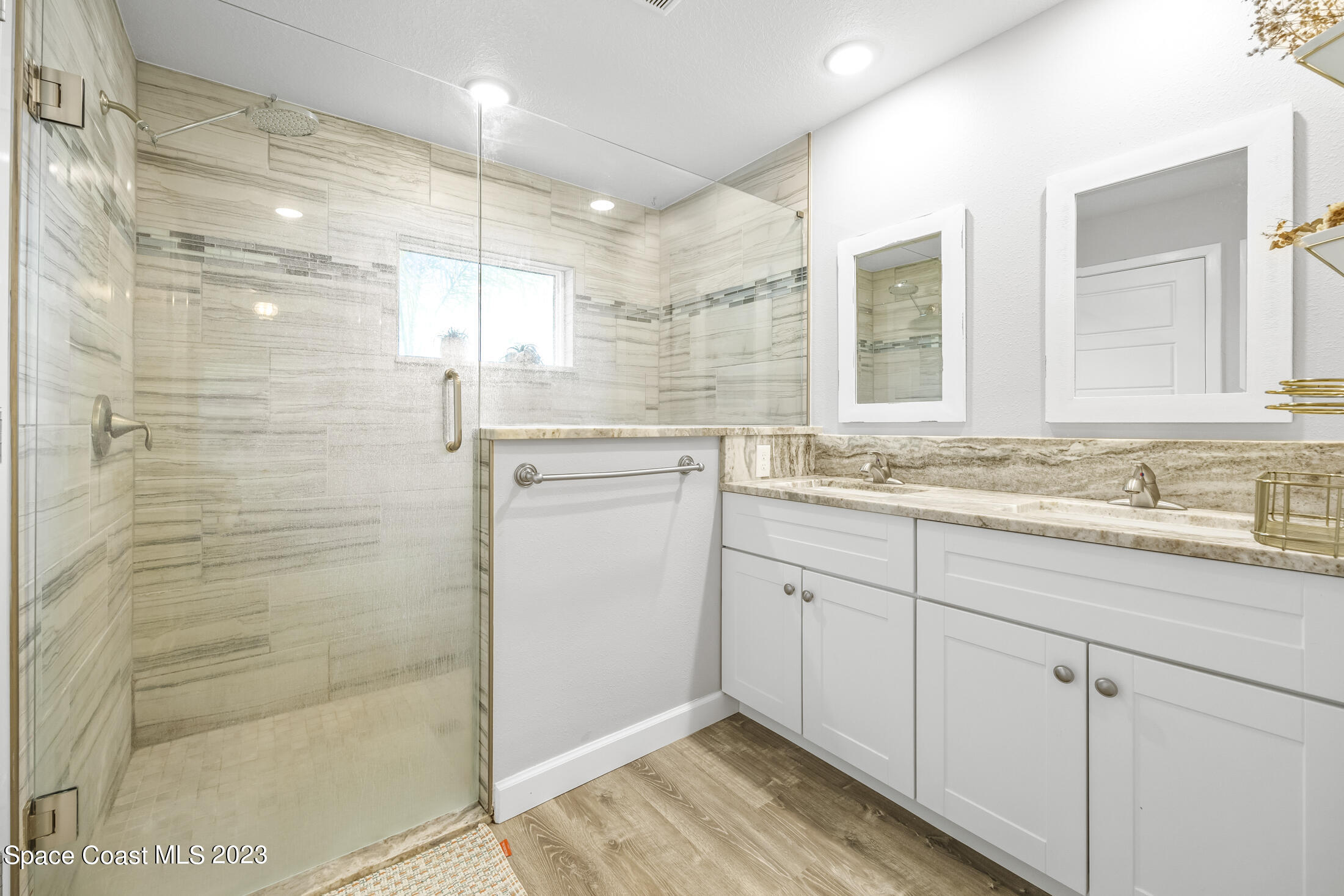 1003 Hayden Road Rockledge, FL 32955 - Photo 3 of 29 a bathroom with a granite countertop sink mirror and shower
