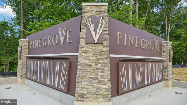 a view of a brick house with a small yard