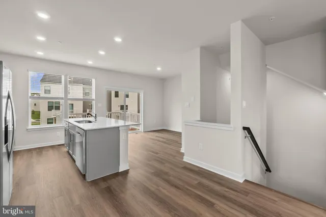 a view of kitchen with wooden floor and electronic appliances