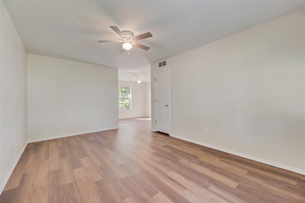 751 County Road 1240 Mount Pleasant, TX 75455 - Photo 9 of 35 a view of an empty room with wooden floor and a ceiling fan