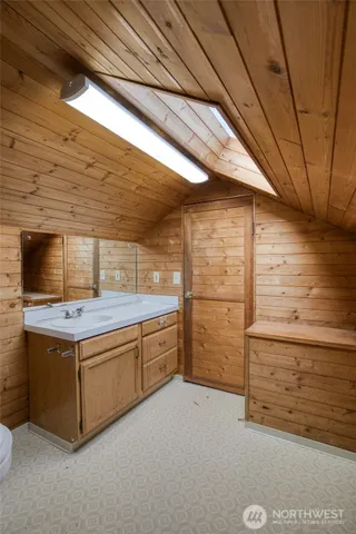a bathroom with a sink a toilet and mirror