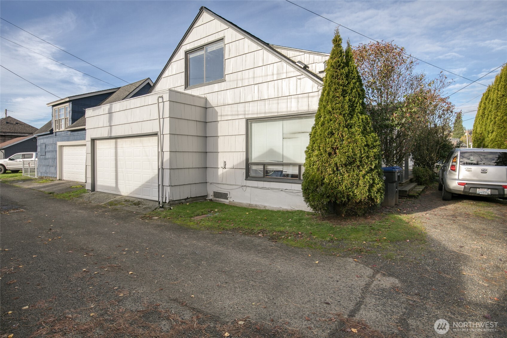411 West 4th Street Aberdeen, WA 98520 - Photo 31 of 40 a view of a house with a backyard and garage