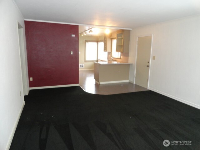 411 West 4th Street Aberdeen, WA 98520 - Photo 39 of 40 an empty room with wooden floor and windows