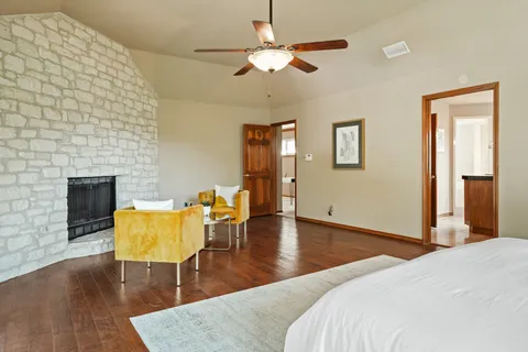 a bedroom with furniture and a fireplace