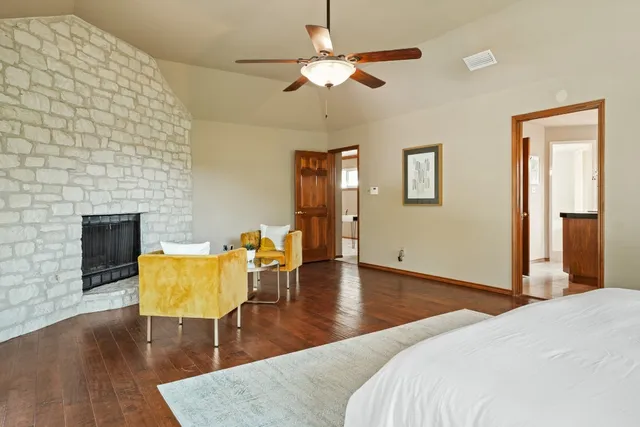 a bedroom with furniture and a fireplace