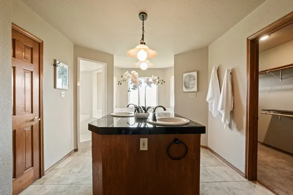 a kitchen with stainless steel appliances granite countertop a sink and a refrigerator