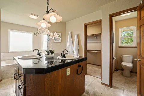 a bathroom with a sink a toilet and a mirror