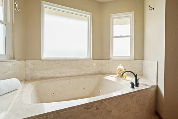 a bathroom with a bathtub and a window