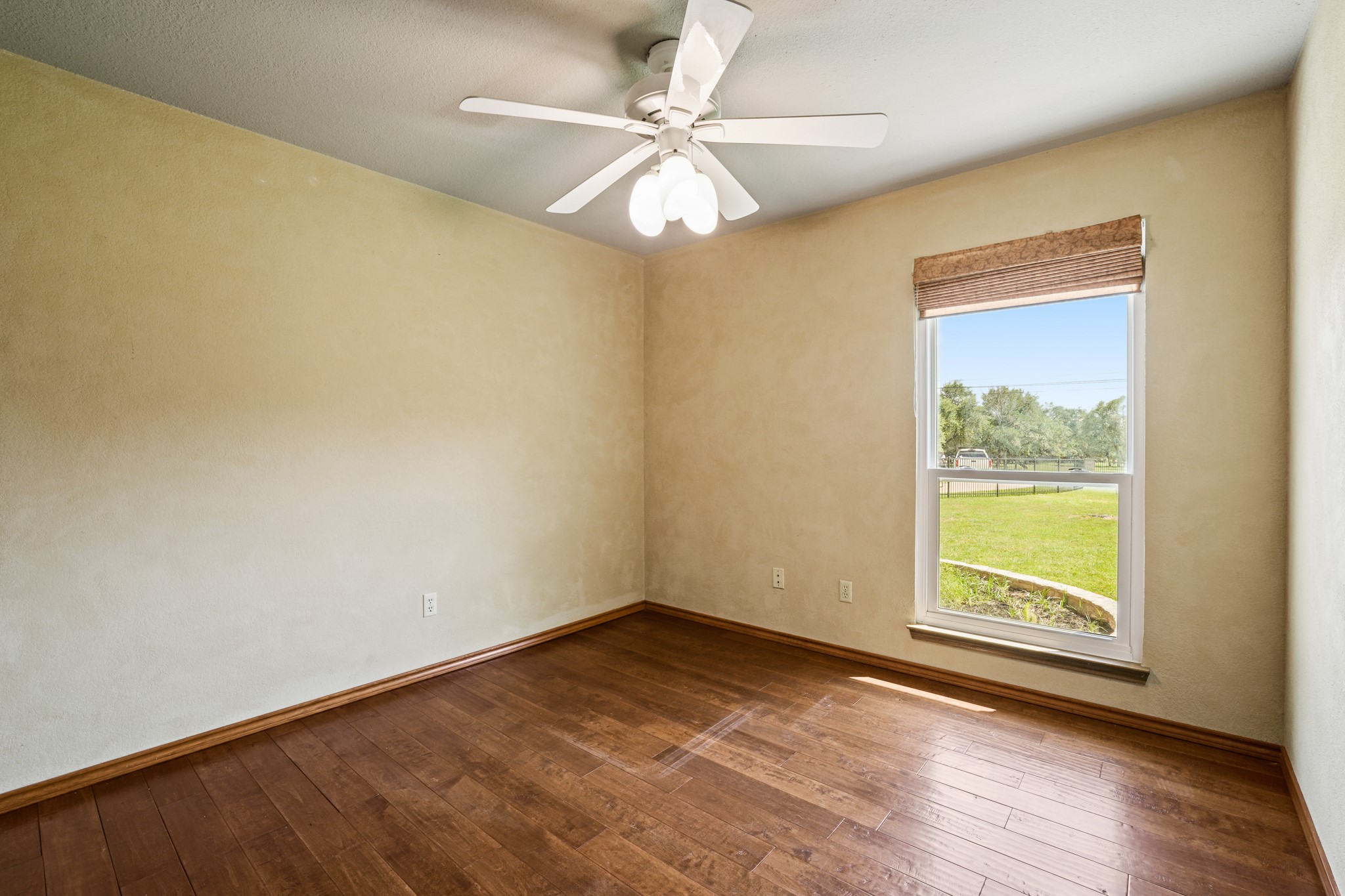 176 Logan Ranch Road Georgetown, TX 78628 - Photo 20 of 38 a view of an empty room with window and wooden floor