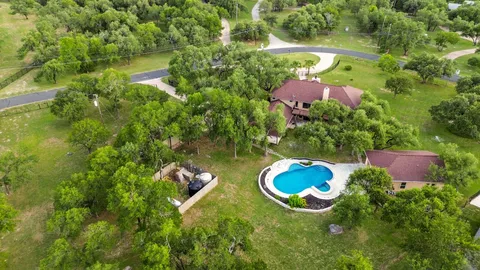 an aerial view of a house with yard swimming pool and outdoor seating