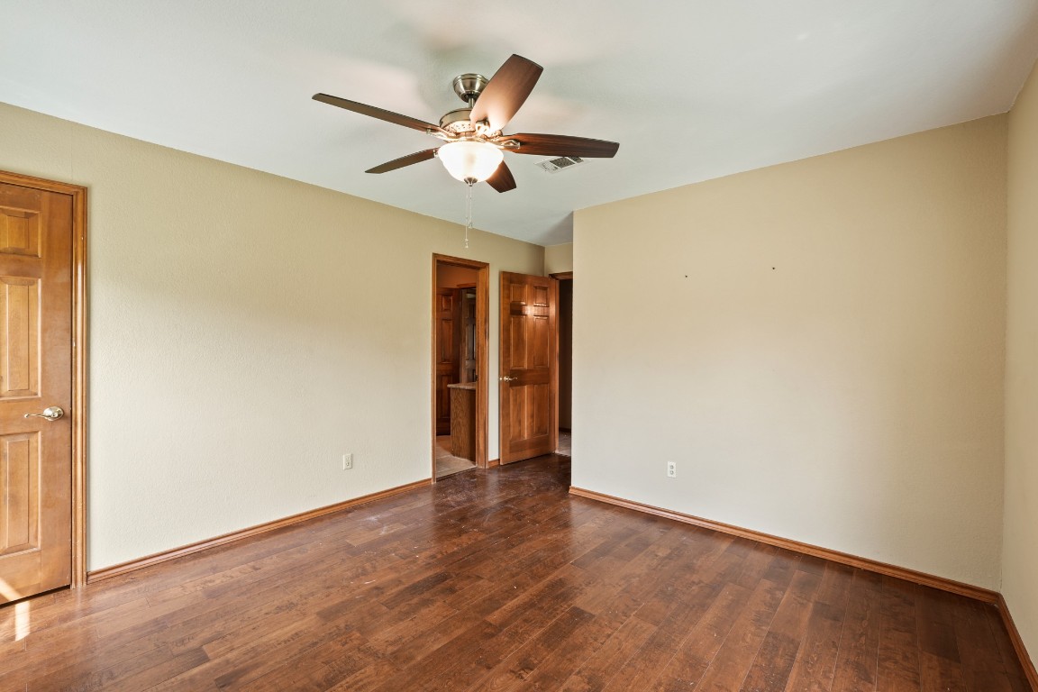 176 Logan Ranch Road Georgetown, TX 78628 - Photo 23 of 38 a view of an empty room with wooden floor and a window