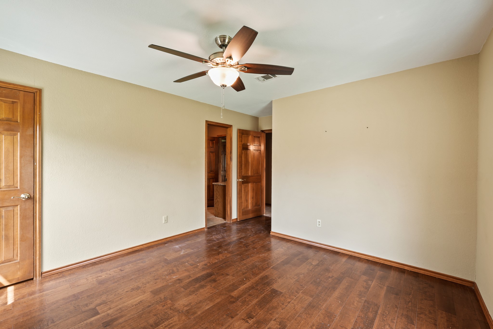 176 Logan Ranch Road Georgetown, TX 78628 - Photo 23 of 38 a view of an empty room with wooden floor and a window