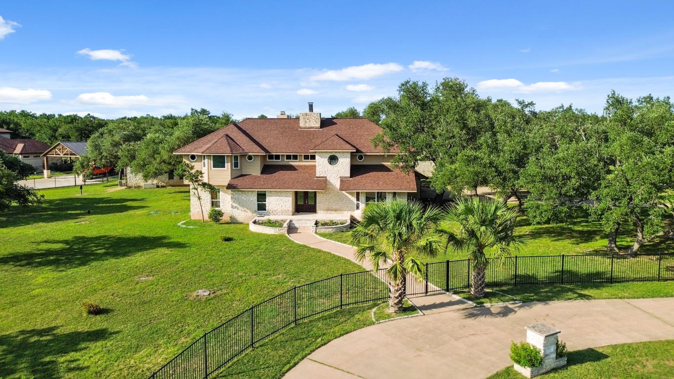 176 Logan Ranch Road Georgetown, TX 78628 - Photo 3 of 38 a view of a white house with a big yard plants and large trees