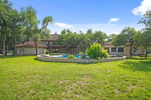 a house view with swimming pool in front of it