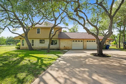 a view of a large trees in front of a house
