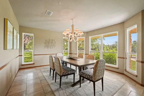 a view of a dining room with furniture and a window