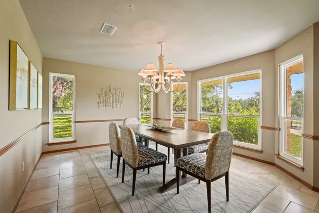 a view of a dining room with furniture and a window