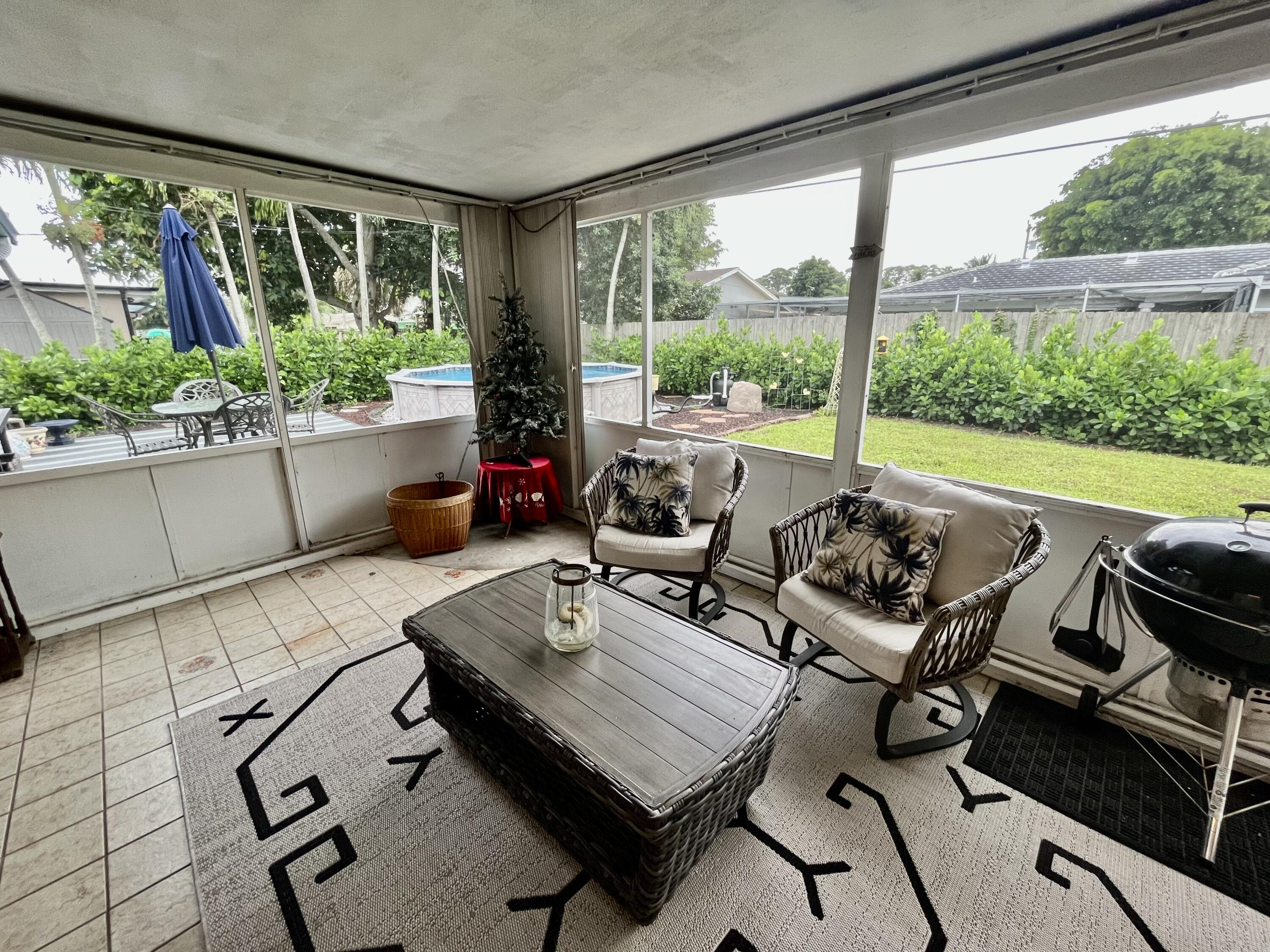 2016 Bonnie Street Boca Raton, FL 33486 - Photo 25 of 28 a living room with patio furniture and a potted plant