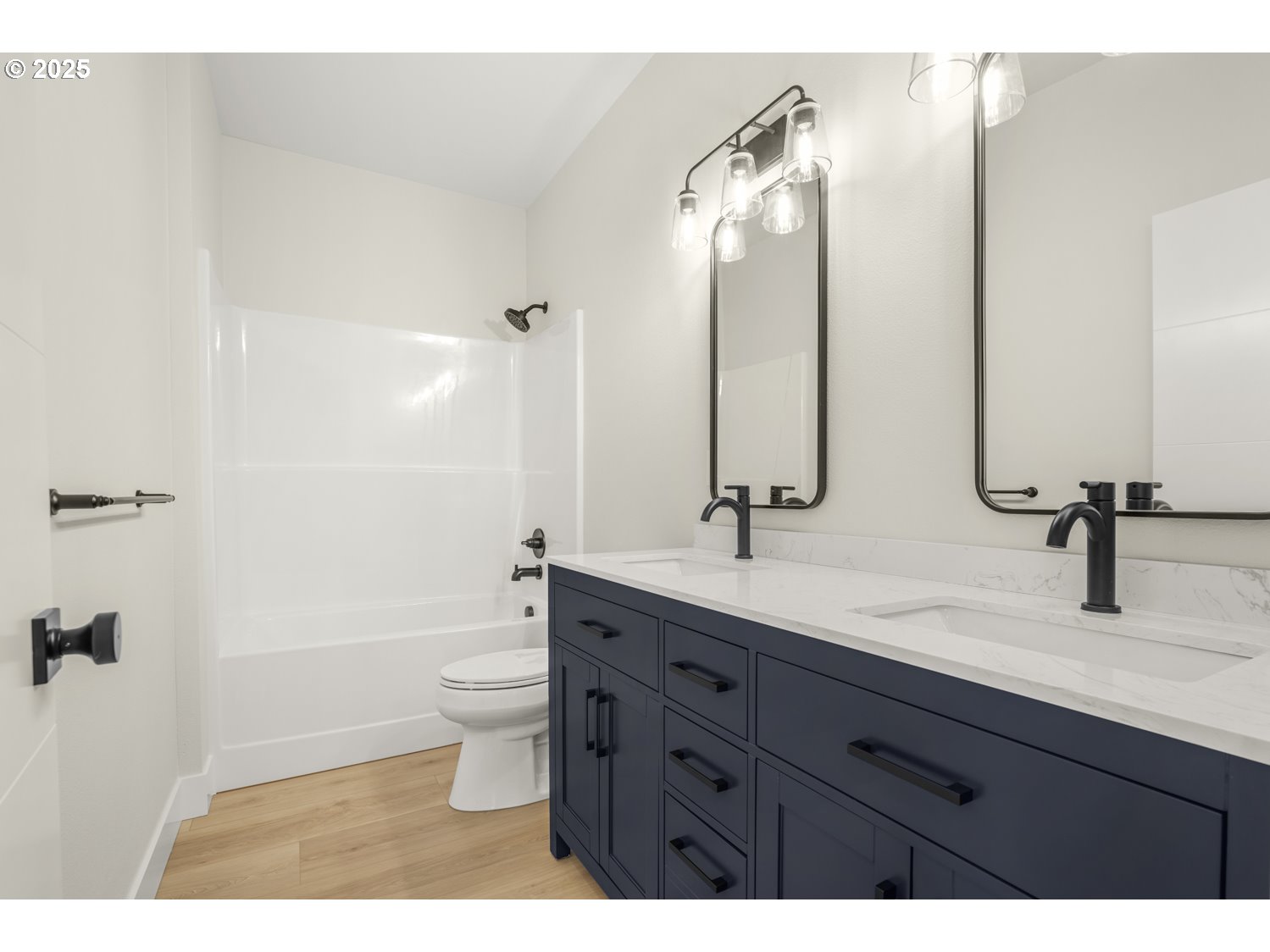 4165 Z Street Washougal, WA 98671 - Photo 22 of 40 a bathroom with a double vanity sink toilet mirror and shower