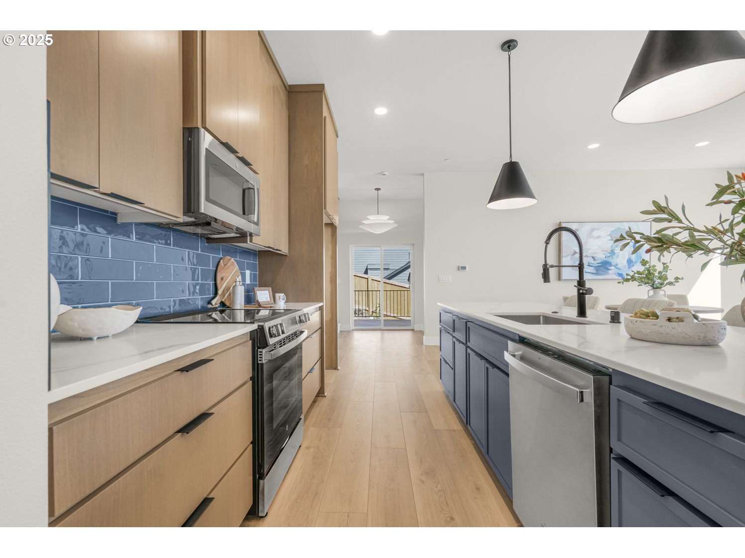 4165 Z Street Washougal, WA 98671 - Photo 10 of 40 a kitchen with stainless steel appliances granite countertop a sink a stove and a wooden floors