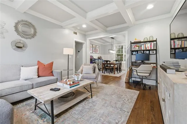 a living room with furniture a rug and a bookshelf
