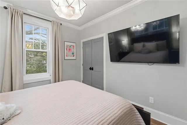a bedroom with a bed and a flat screen tv