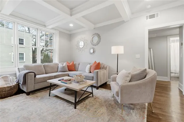 a living room with furniture and a lamp