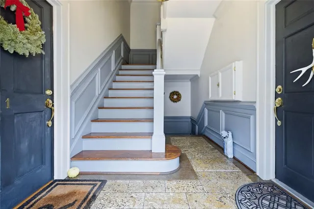 a view of entryway and hall with wooden floor