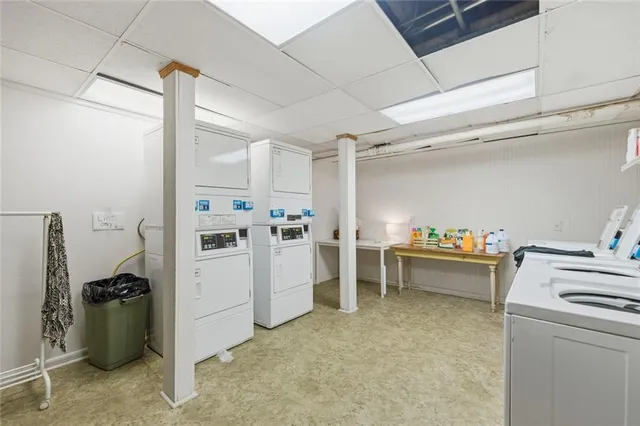 a kitchen with a refrigerator and white cabinets